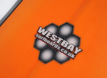 Westbay orange surf board close up